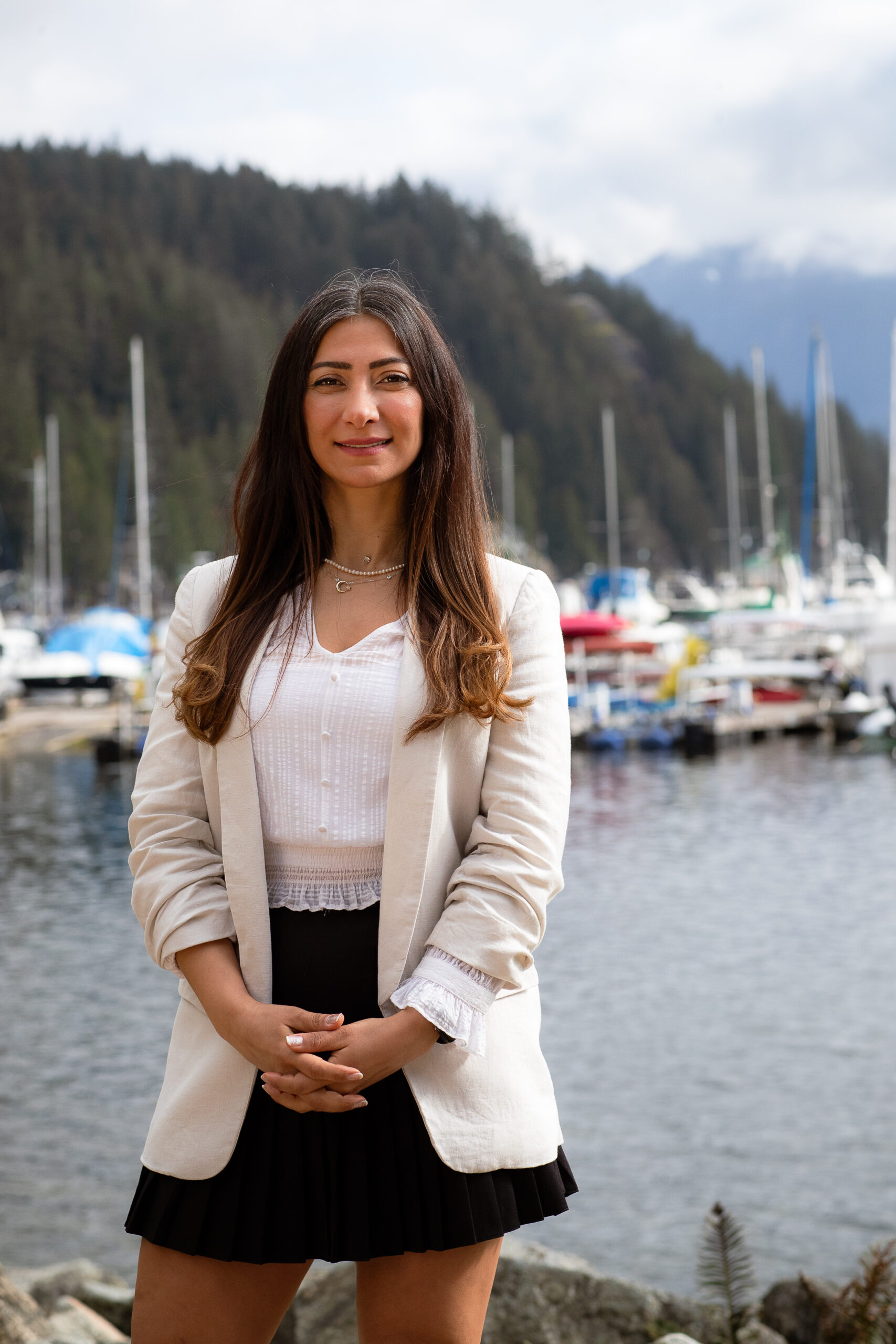 Dental Pathways Founder, Elif Gunaydin Nathoo, standing with water and boats in the background.