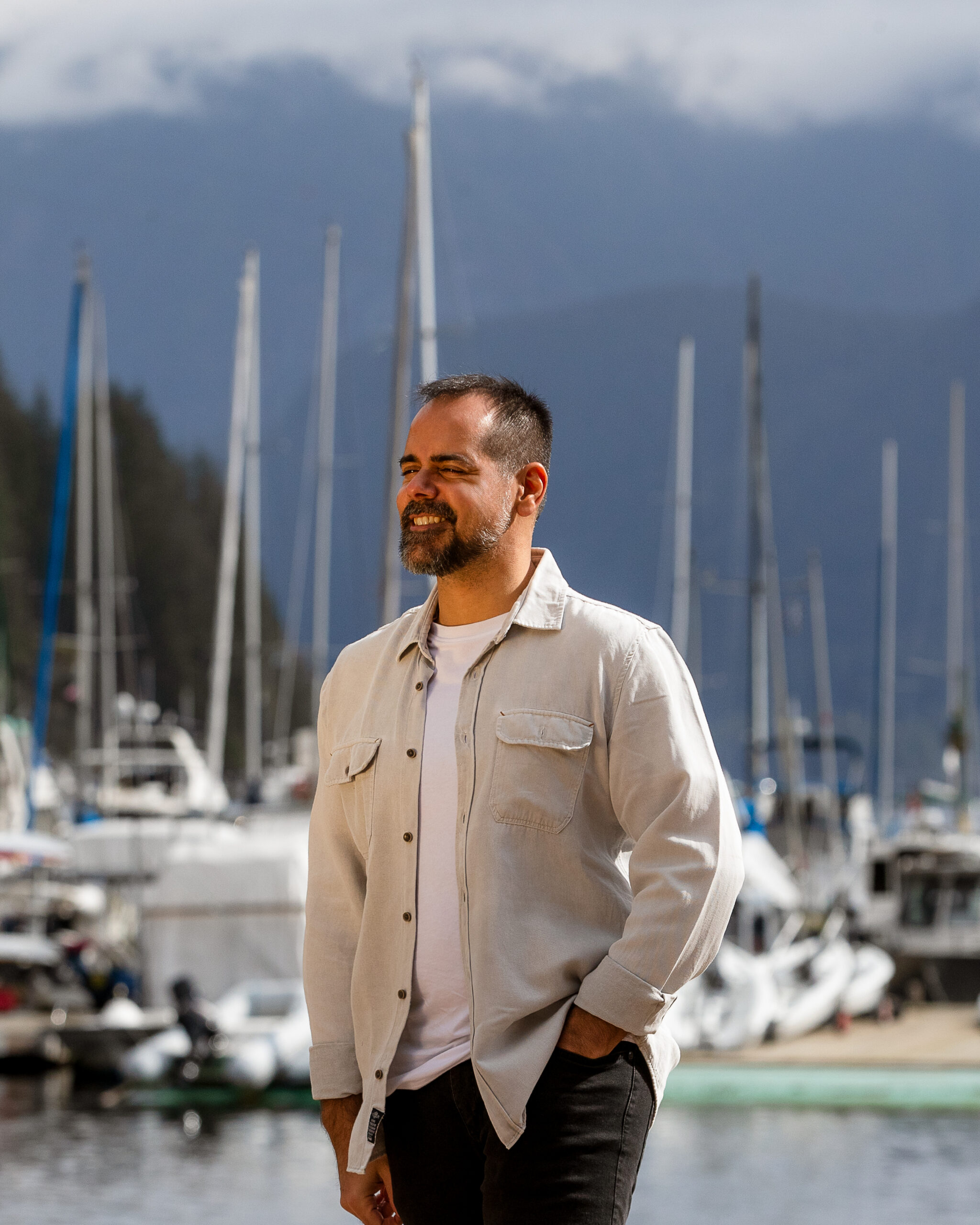 Dental Pathways Founder, Zahir, Standing with water, mountains and boats in the background.